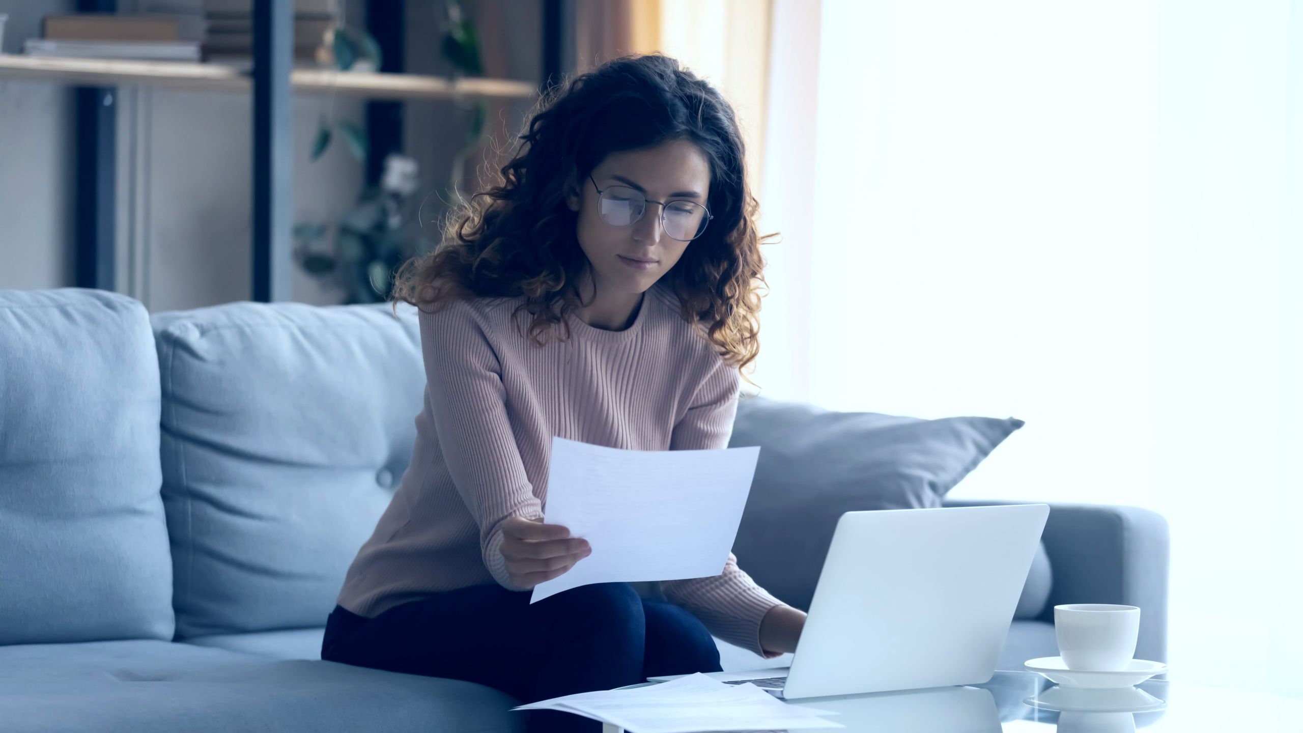 Tax penalty notice and reading glasses on desk representing IRS debt relief services in Tampa